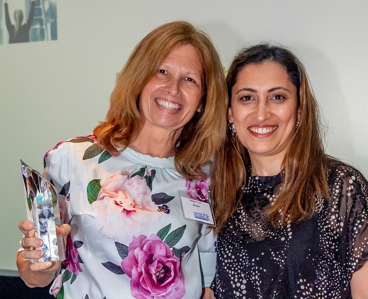 Two women with award